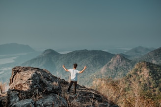 man standing on mountain cliff