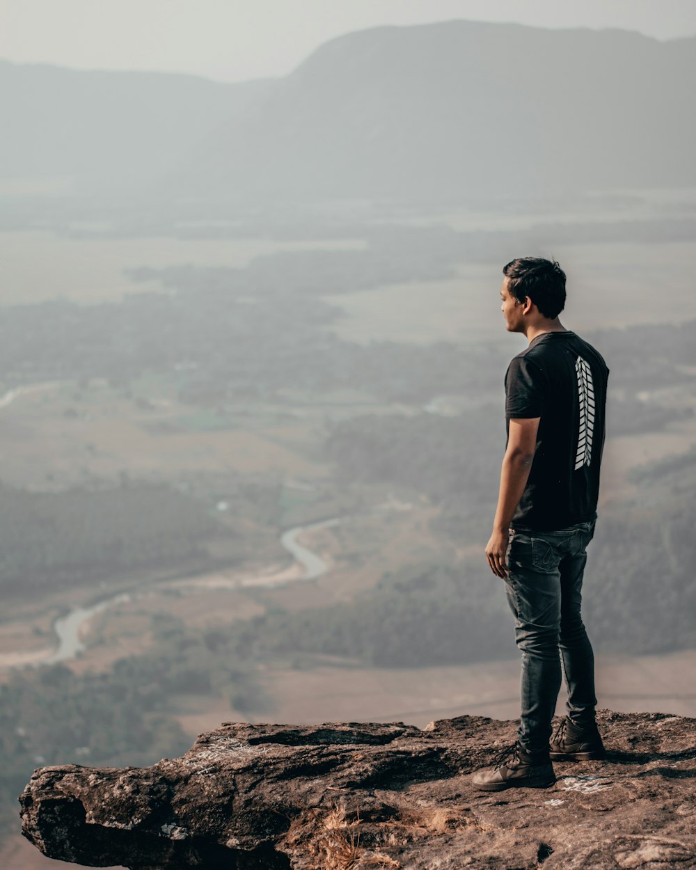 man standing on mountain edge