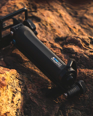 A sleek action camera mounted on a rugged mountain bike handlebar, capturing a thrilling downhill ride.