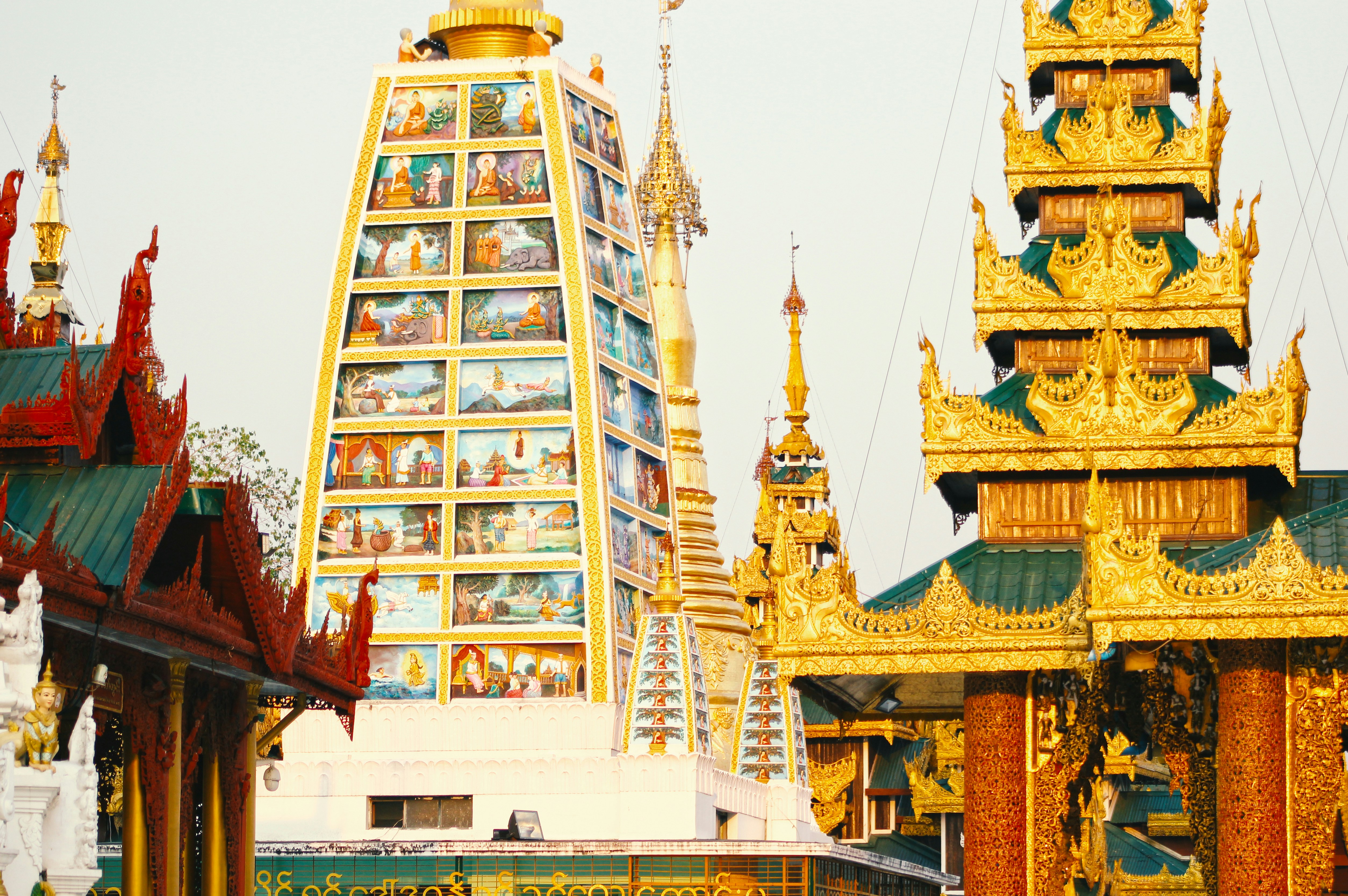 gold and orange temple during daytime, The colorful temples