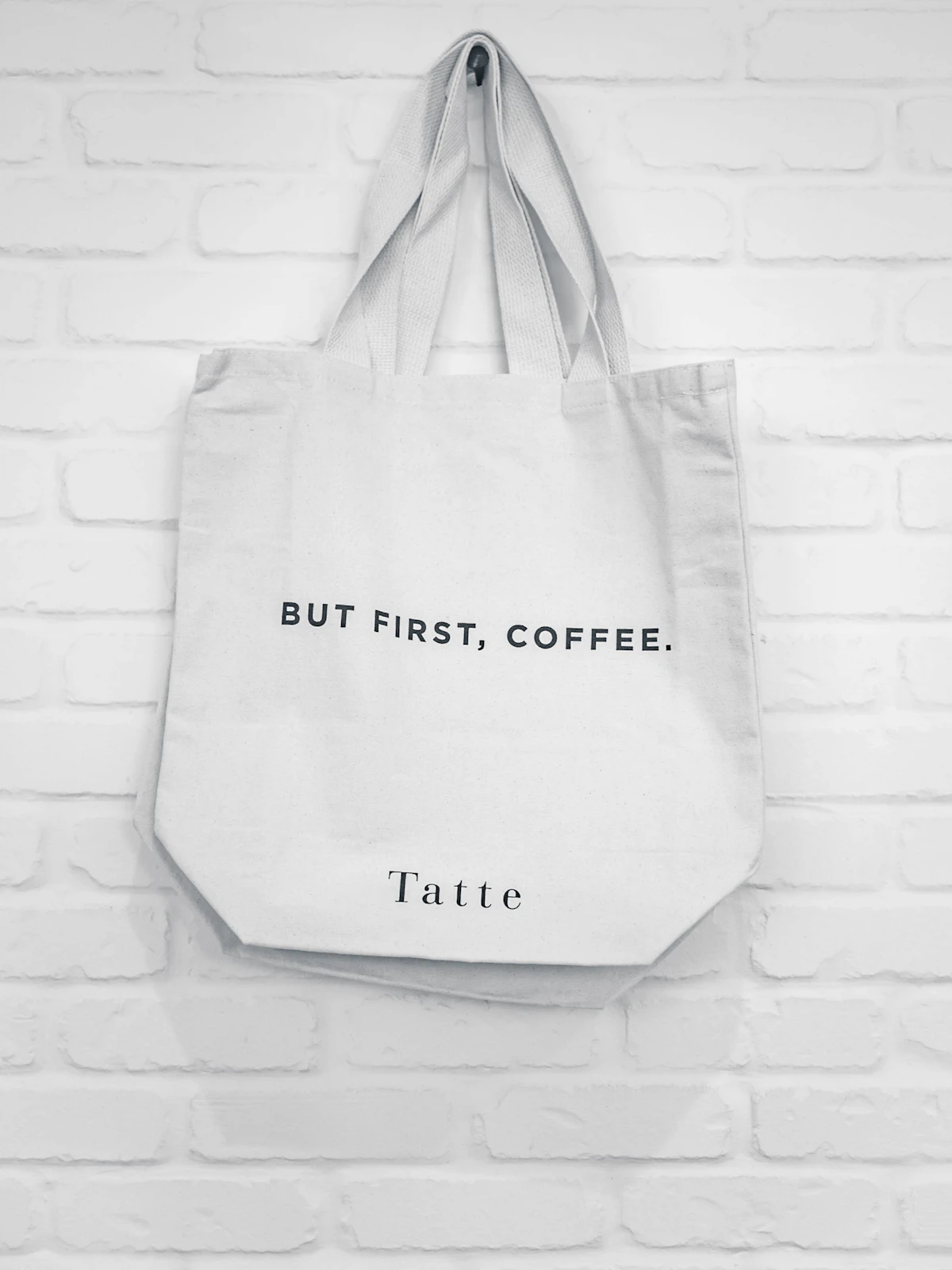 White tote bag shown as a simple daily carry option