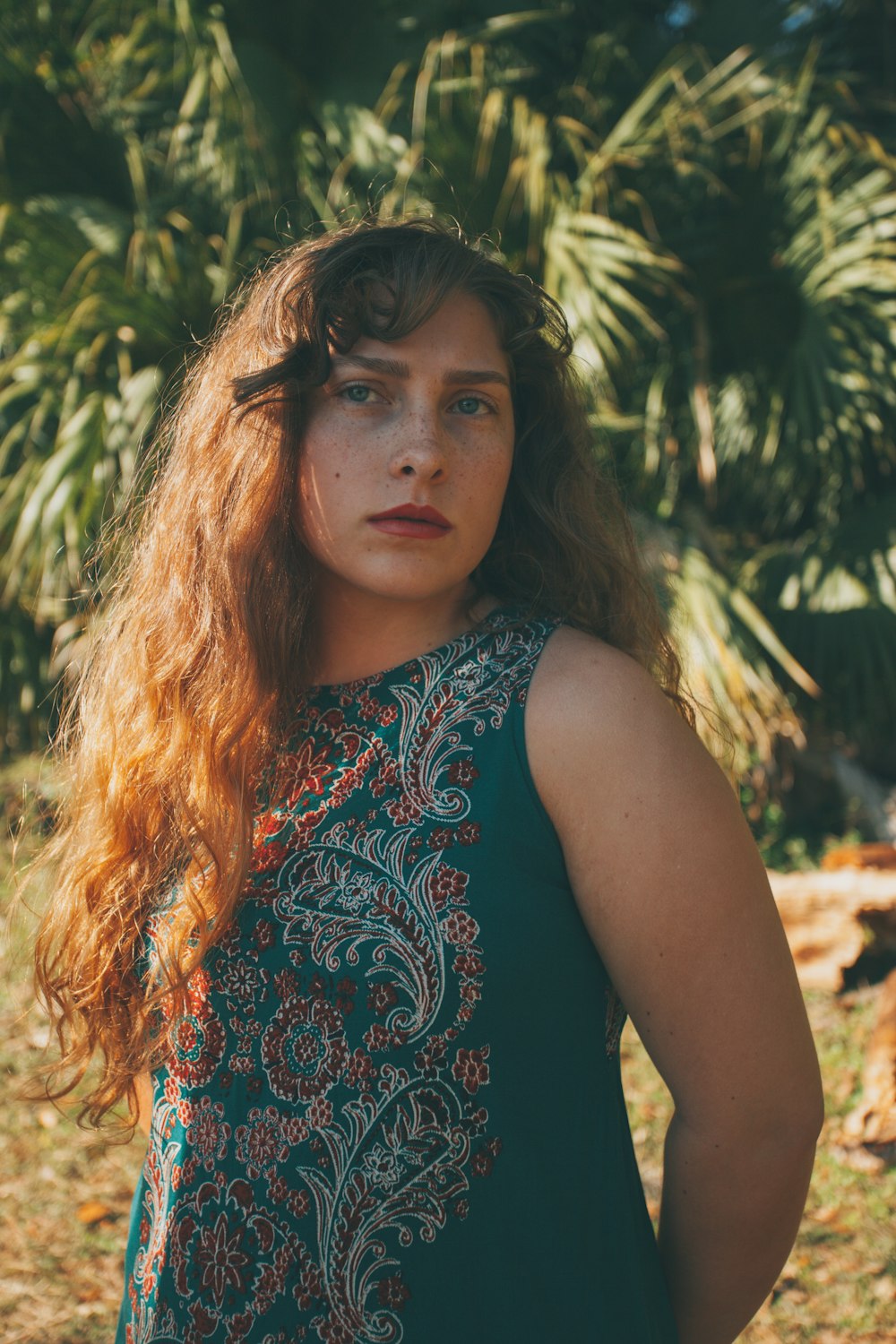 woman wearing green and white sleeveless top