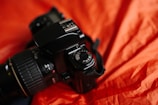 A close-up of a modern digital camera on a table.