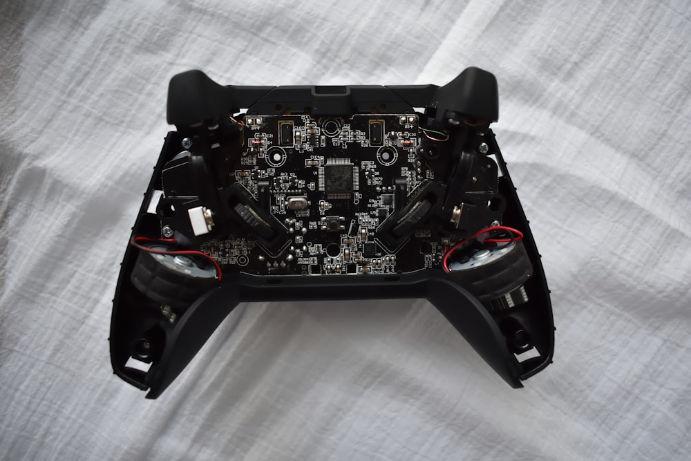 black game controller on white textile