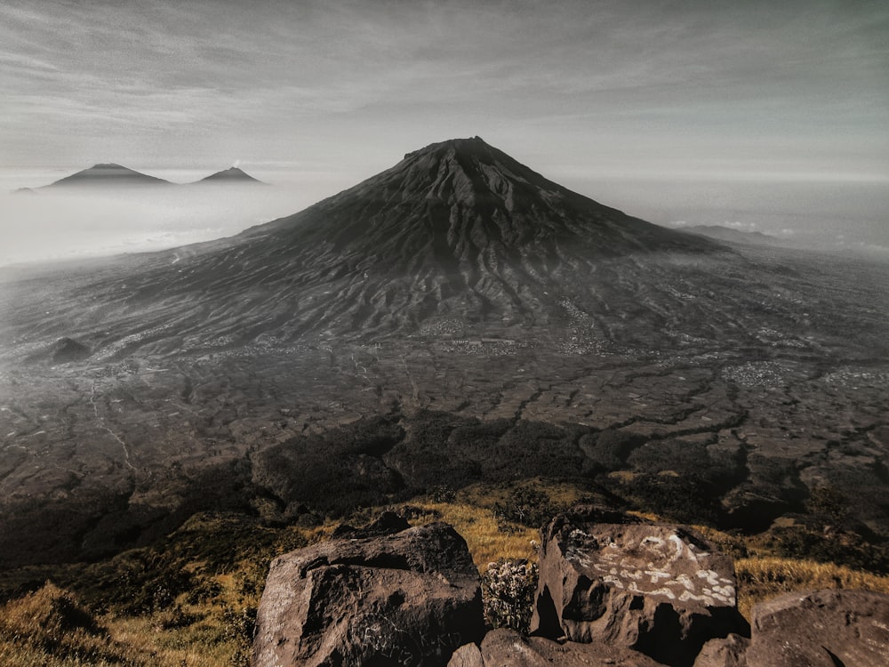 selective color photography of open field mountain