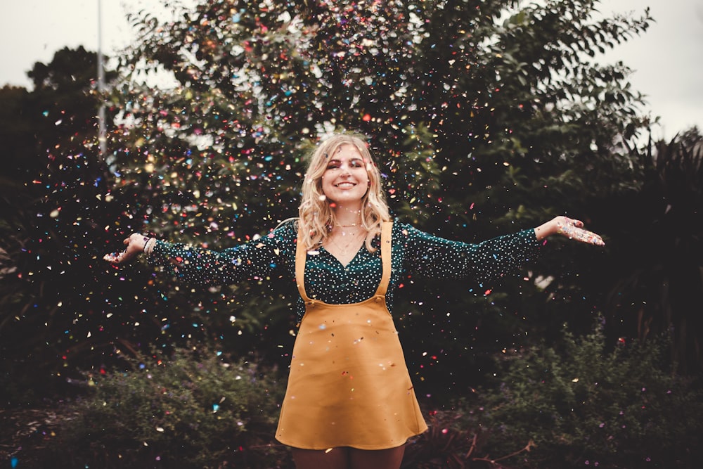 confetti dropping on woman wearing brown jumper skirt