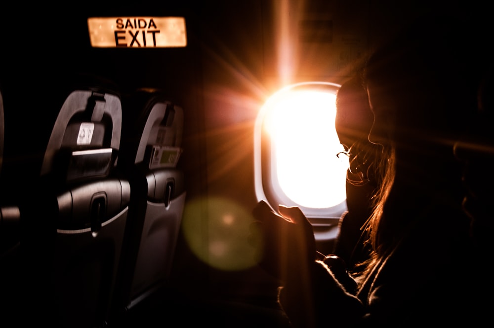woman inside plane on focus photography