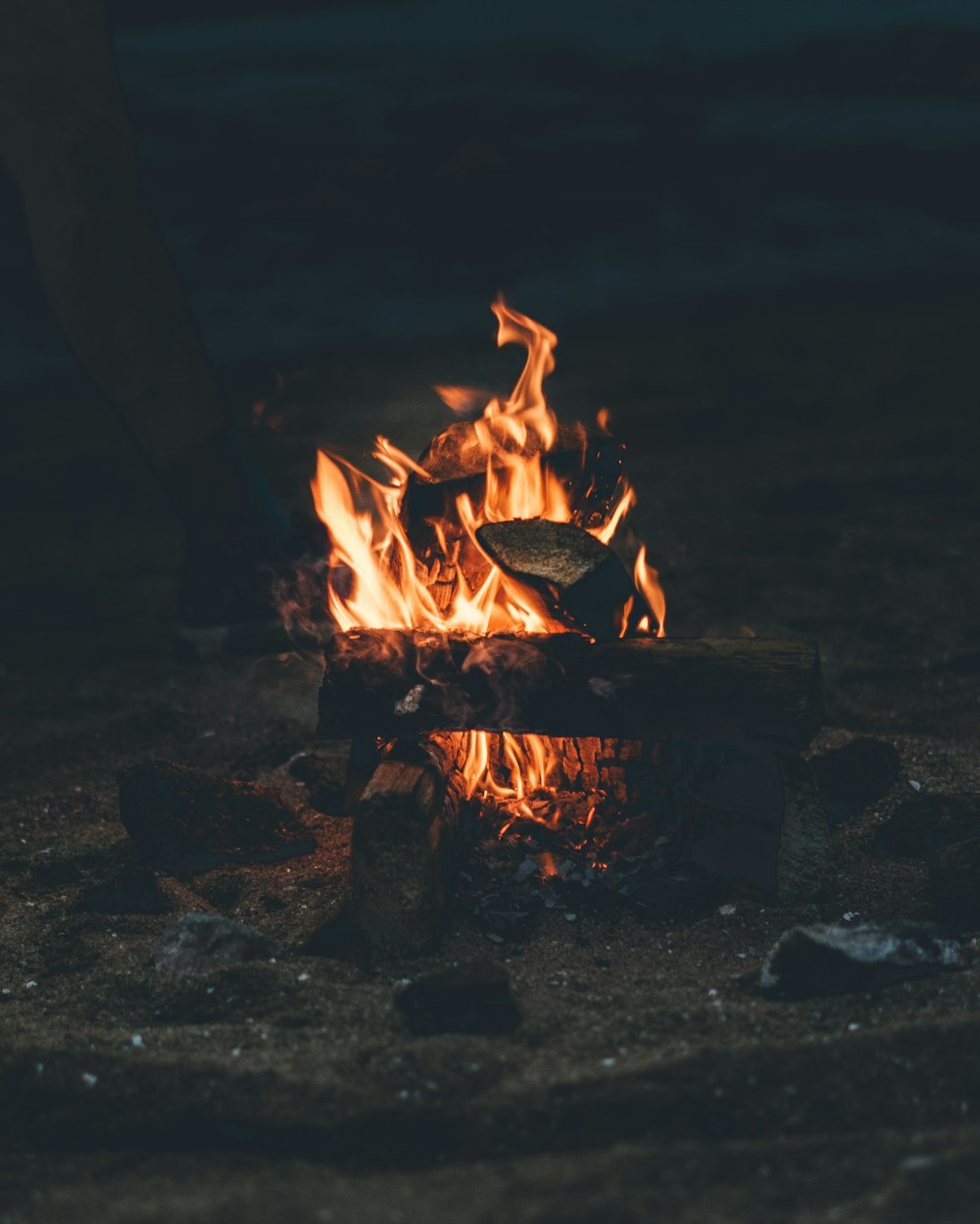 flaming bonfire on grey sand