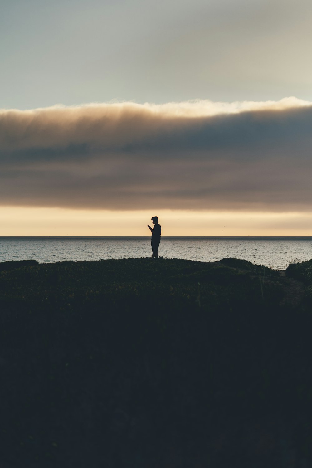 silhouette of man under white cloud