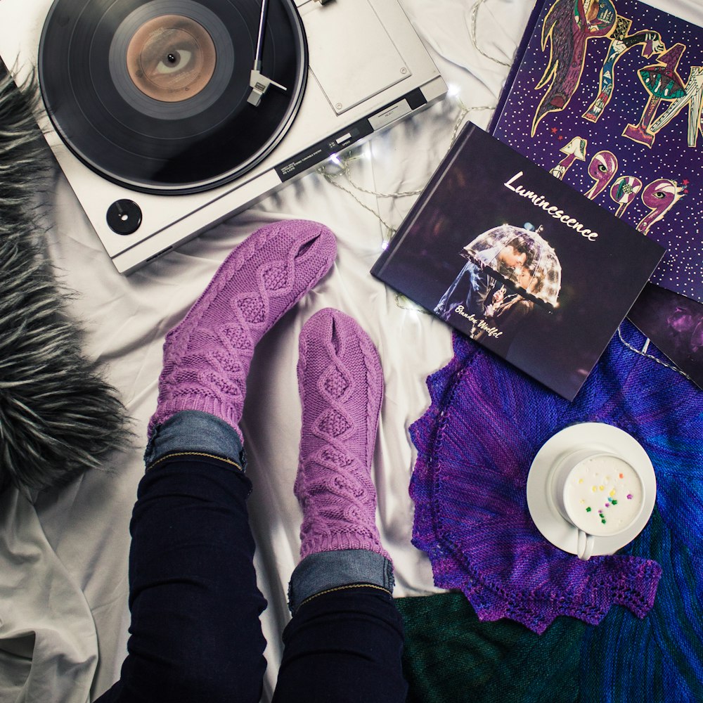 woman's purple socks near turntable