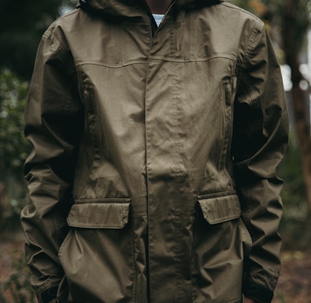 shallow focus photo of man in brown full-zip hoodie