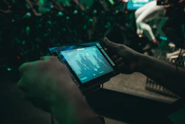 Close-up of a coach reviewing an athlete's progress on a digital tablet.