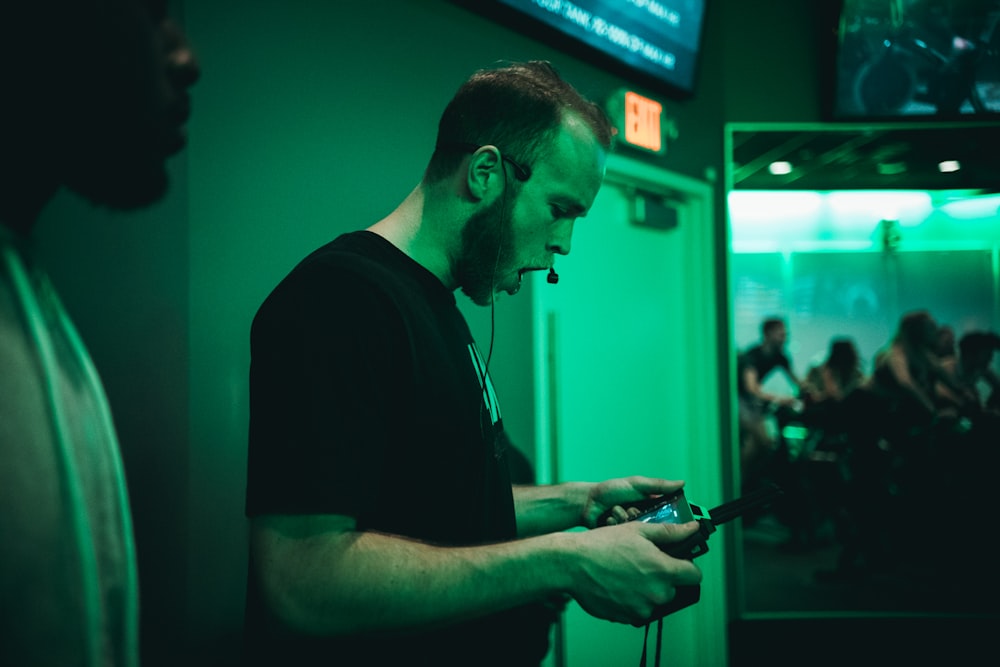 man holding game pad while shouting inside room