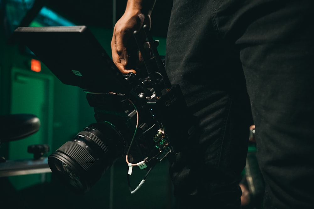 person holding black DSLR camera