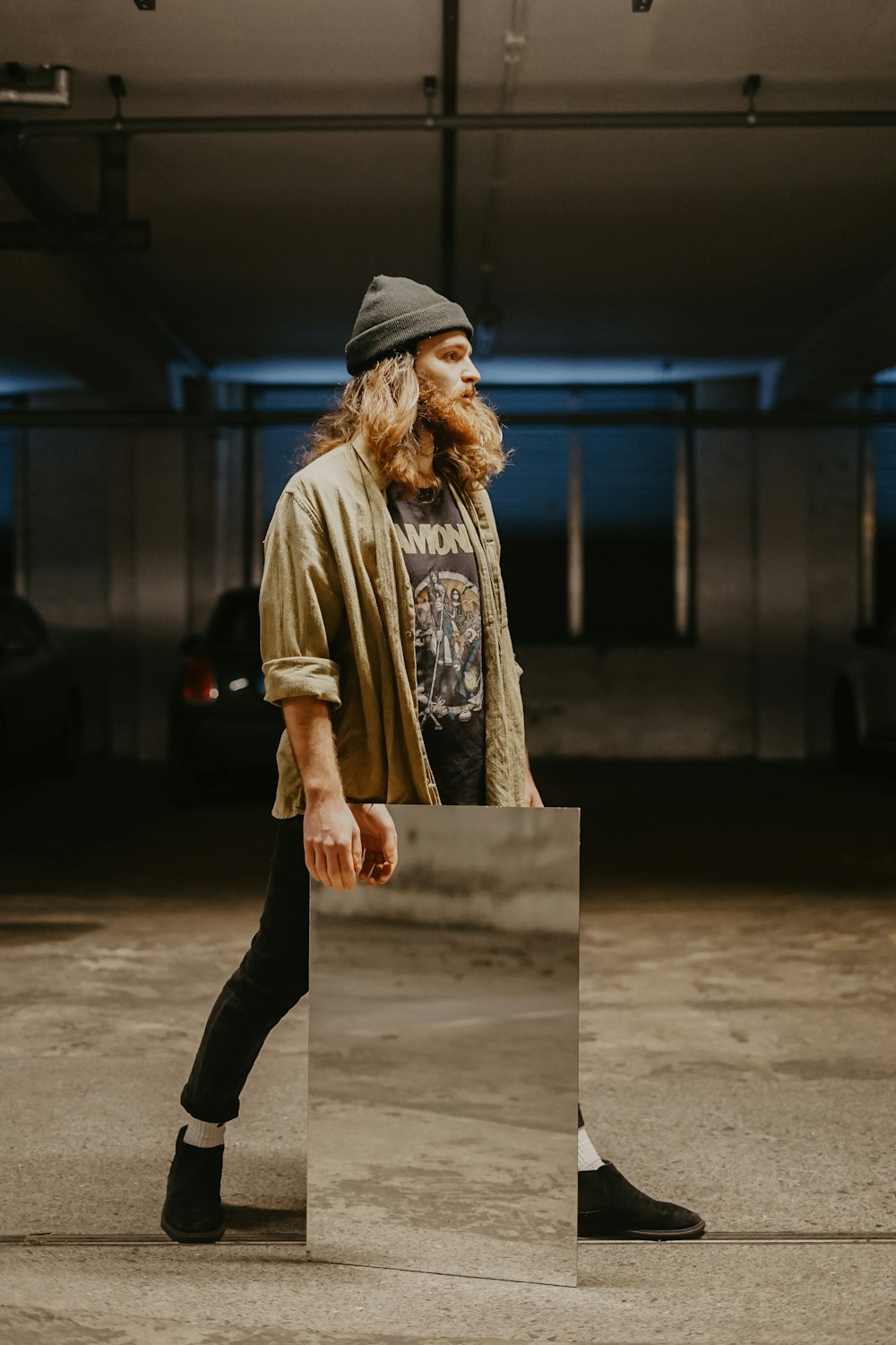 man in gray knit cap holding gray panel