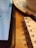 Close-up of a notebook and laptop with notes and sketches on a wooden desk.