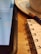 A close-up of a notebook and pen next to a laptop displaying financial graphs.