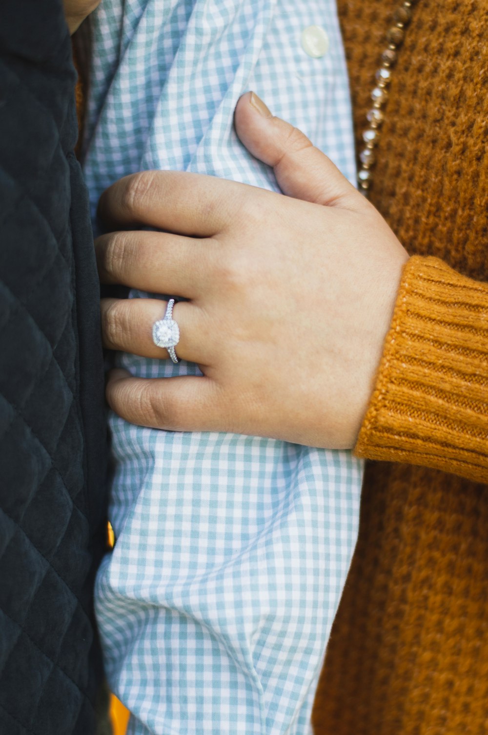 person in yellow knit sweater with silver ring