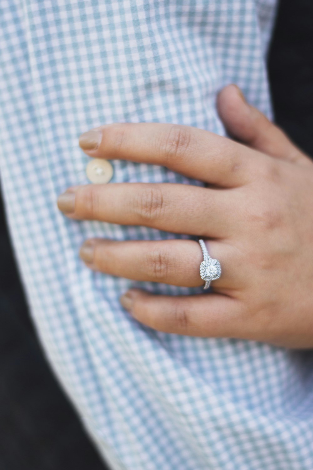 person wearing silver-colored ring with clear gemstones