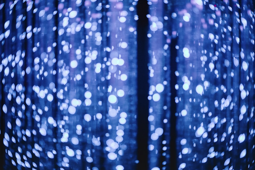 a close up of a blue light with white dots on it