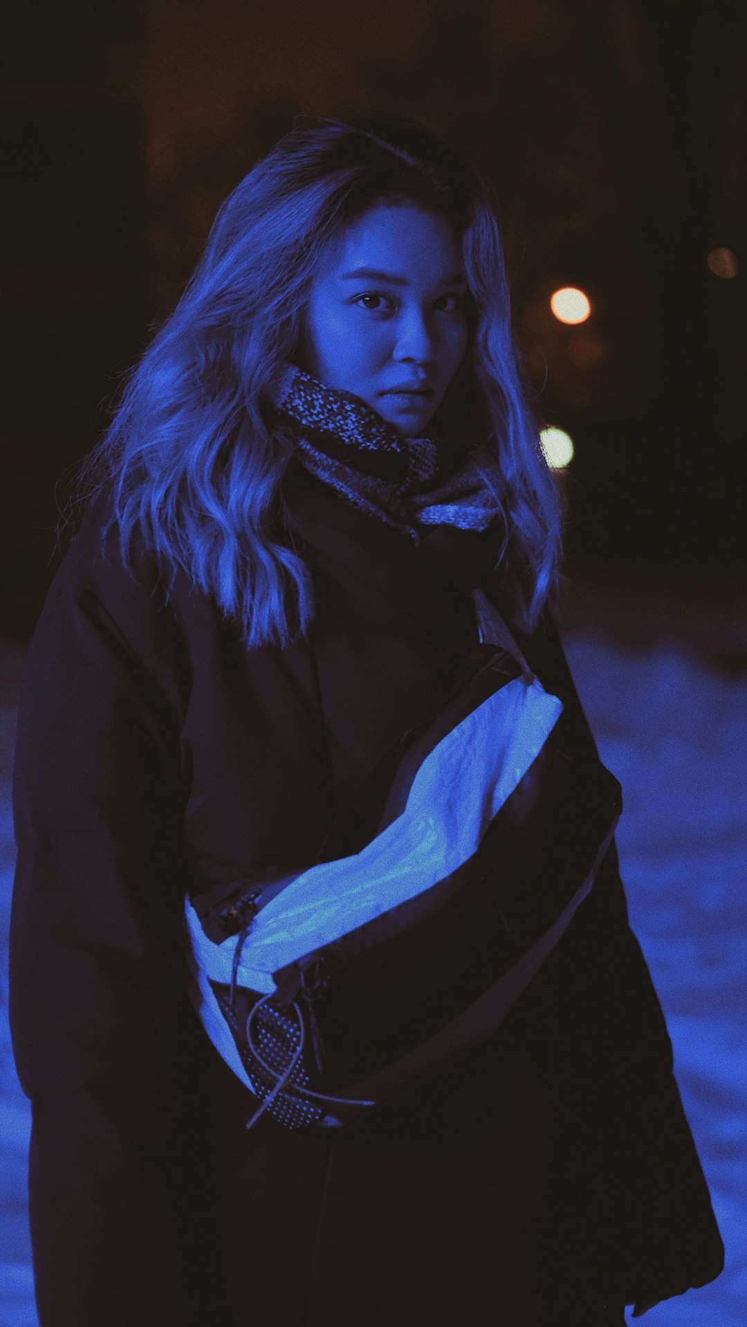 woman wearing thick sweater on snowy outdoors