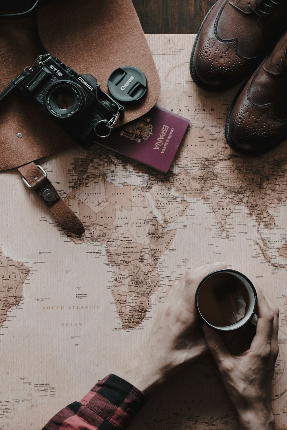 flat lay photo of coffee, bridge camera, and boots