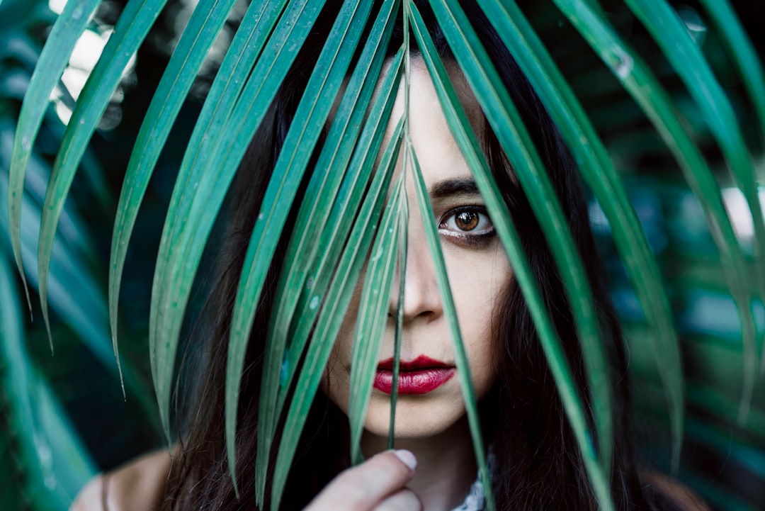 woman hiding on fern leaf