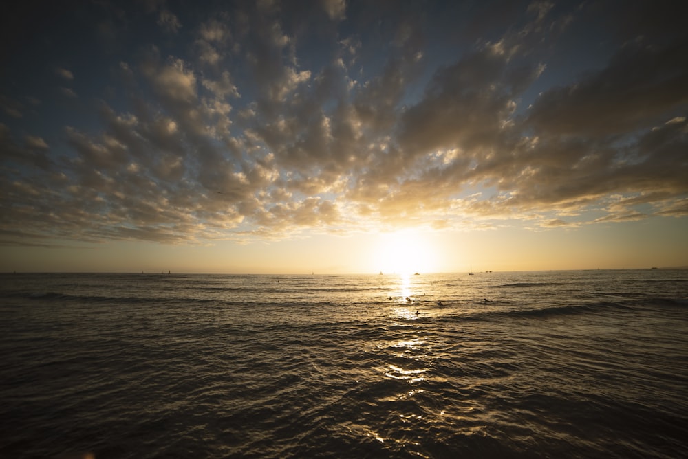 calm sea under white and blue sky