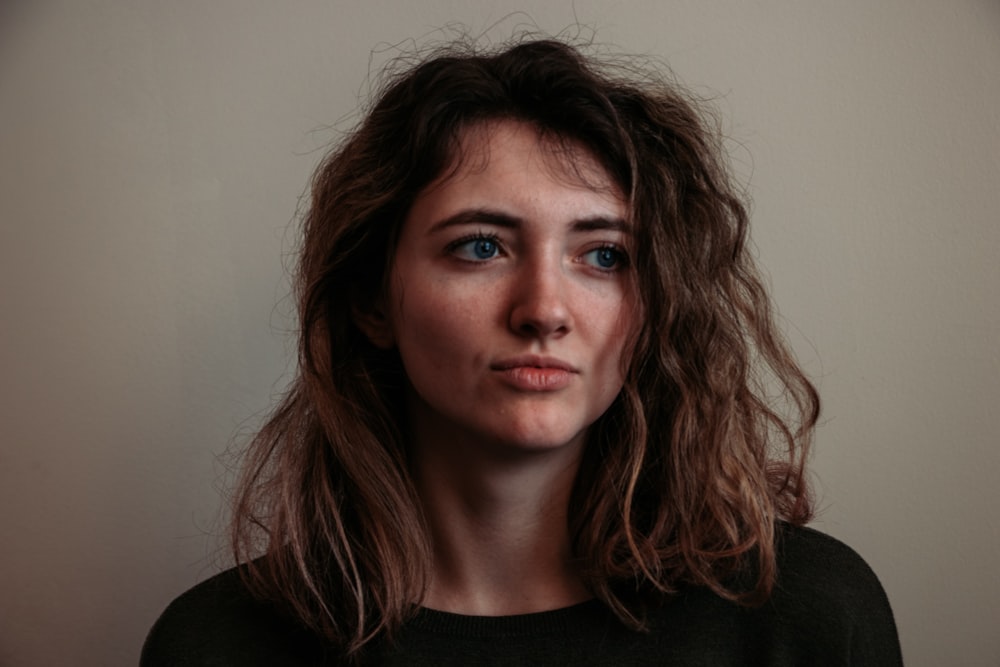 woman standing beside wall