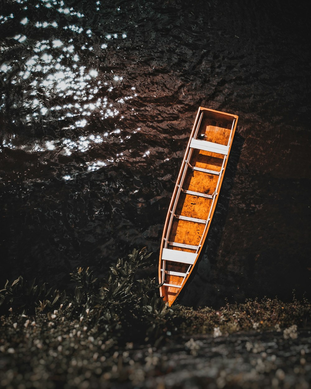 brown boat floating on water