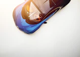 Side view of a sleek sports car with a flawless glossy finish.