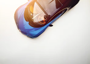 Side view of a sleek sports car with a flawless glossy finish.