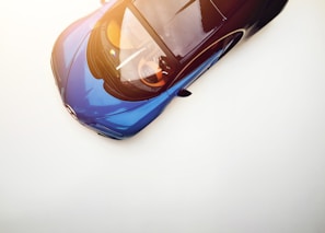 Side view of a sleek used sedan ready for export with a clear blue sky background.