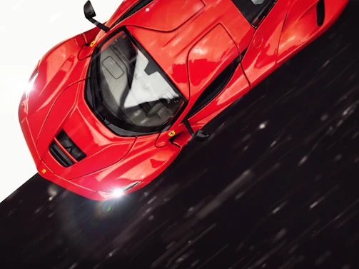 A sleek sports car captured in motion at a vibrant automotive event.