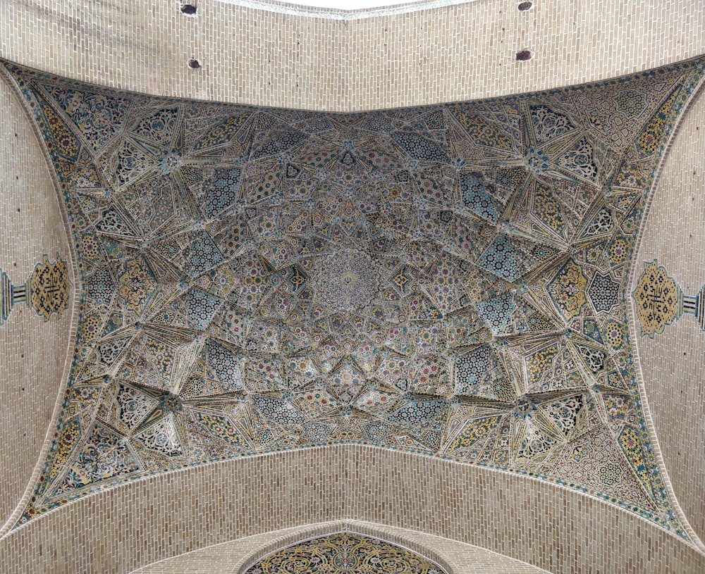 the ceiling of a building with a decorative design on it