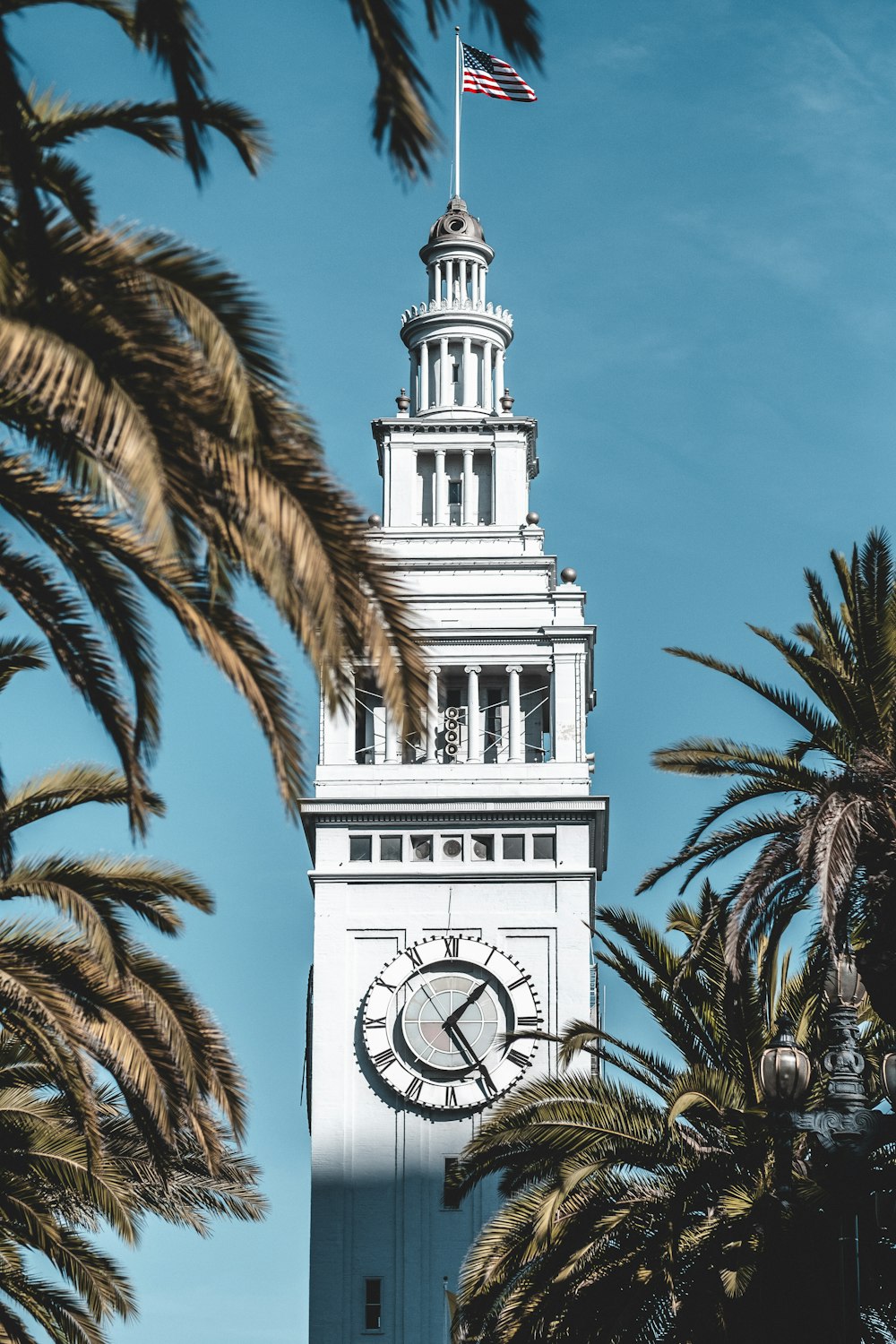 focus photography of white building under blue sky