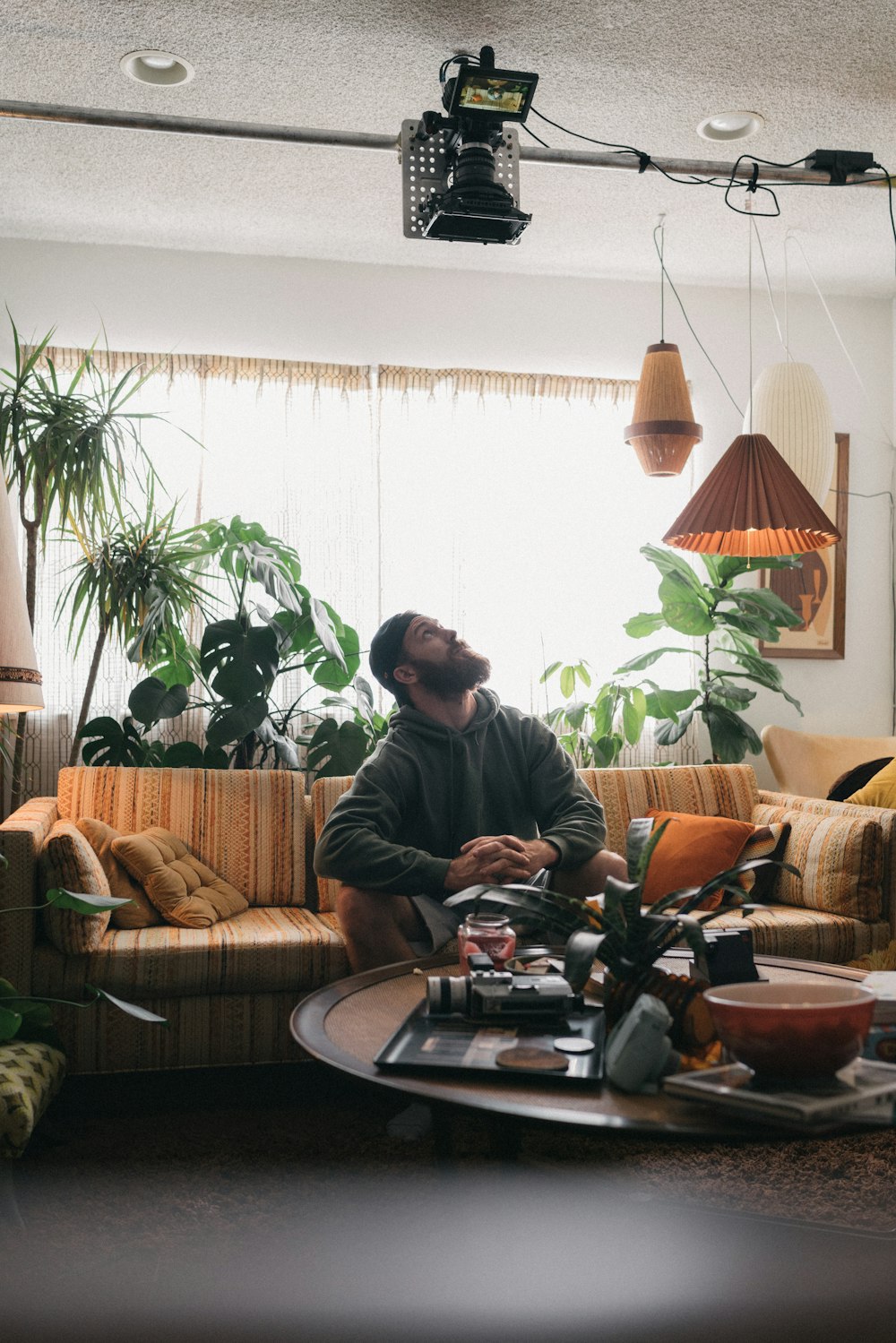 man sitting on sofa near window inside room