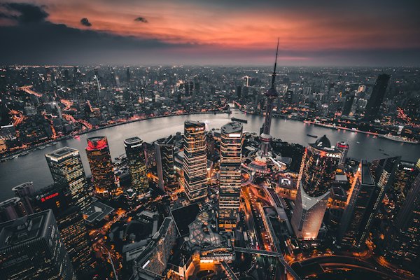 An aerial view of the Shanghai skyline and Huangpu River at golden hour