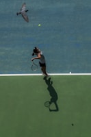 woman about to smash tennis ball during daytime