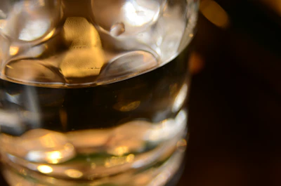 A close-up of a gleaming copper glass filled with water, highlighting its smooth texture and warm hue.