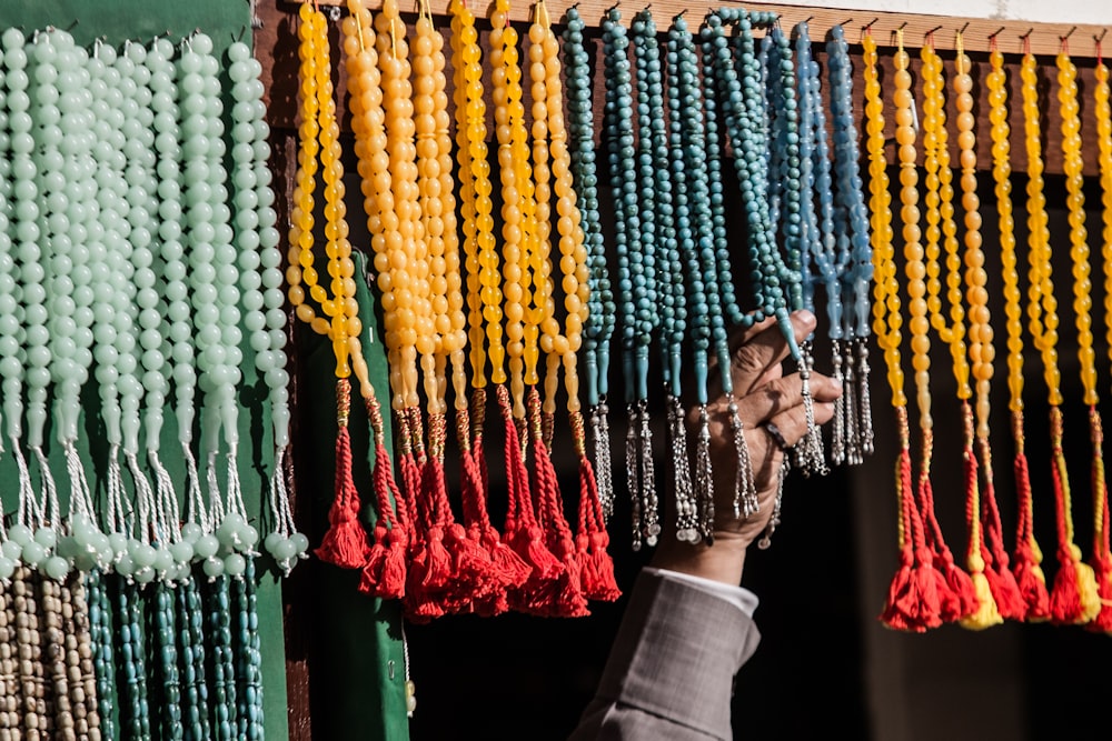 person touching prayer beads