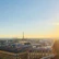 Traveler admiring the Eiffel Tower at sunset in Paris.