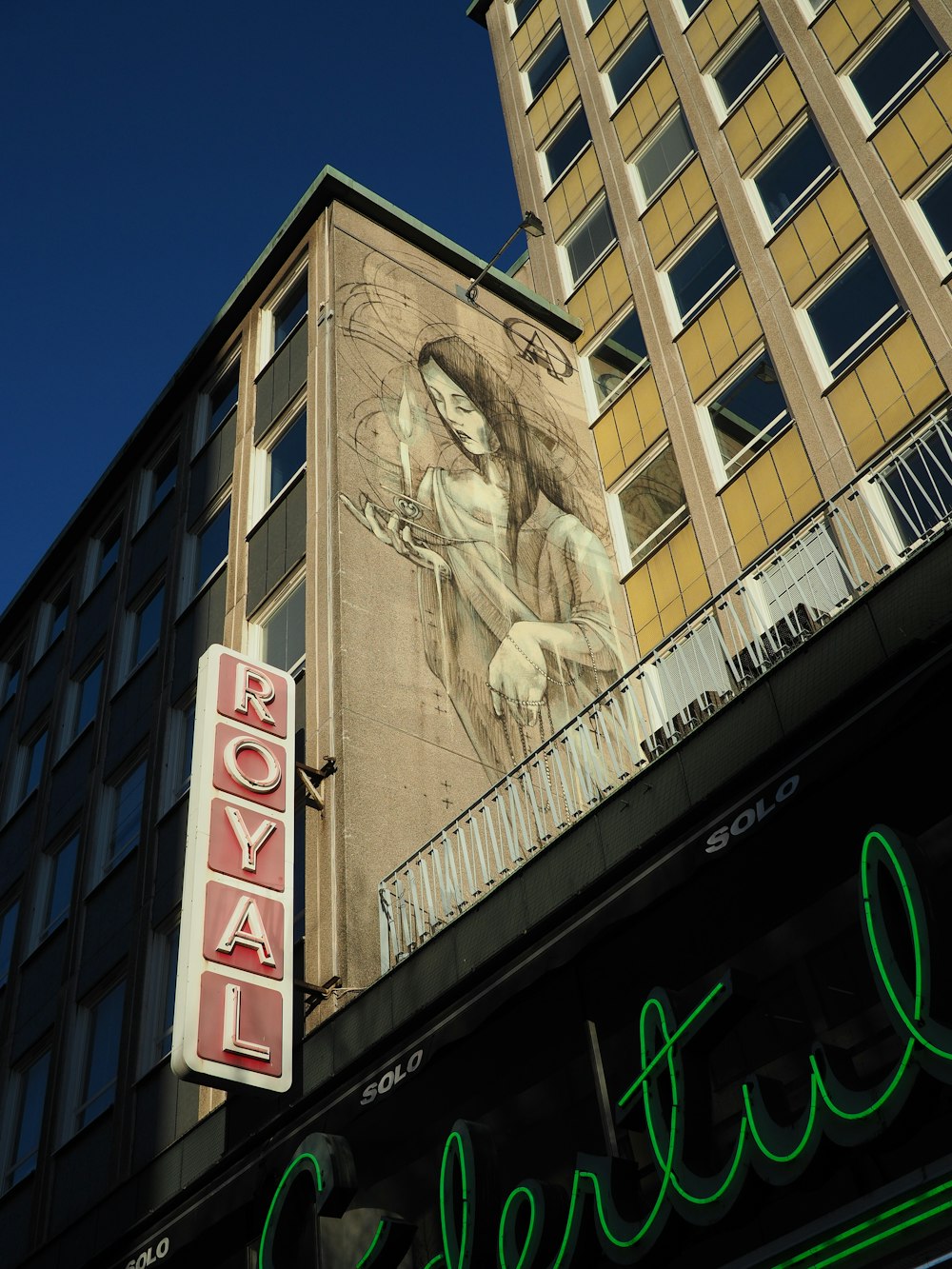 Royal signage mounted on brown concrete multi-storey building