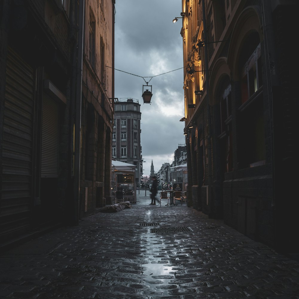 silhouette photo of person walking beside building