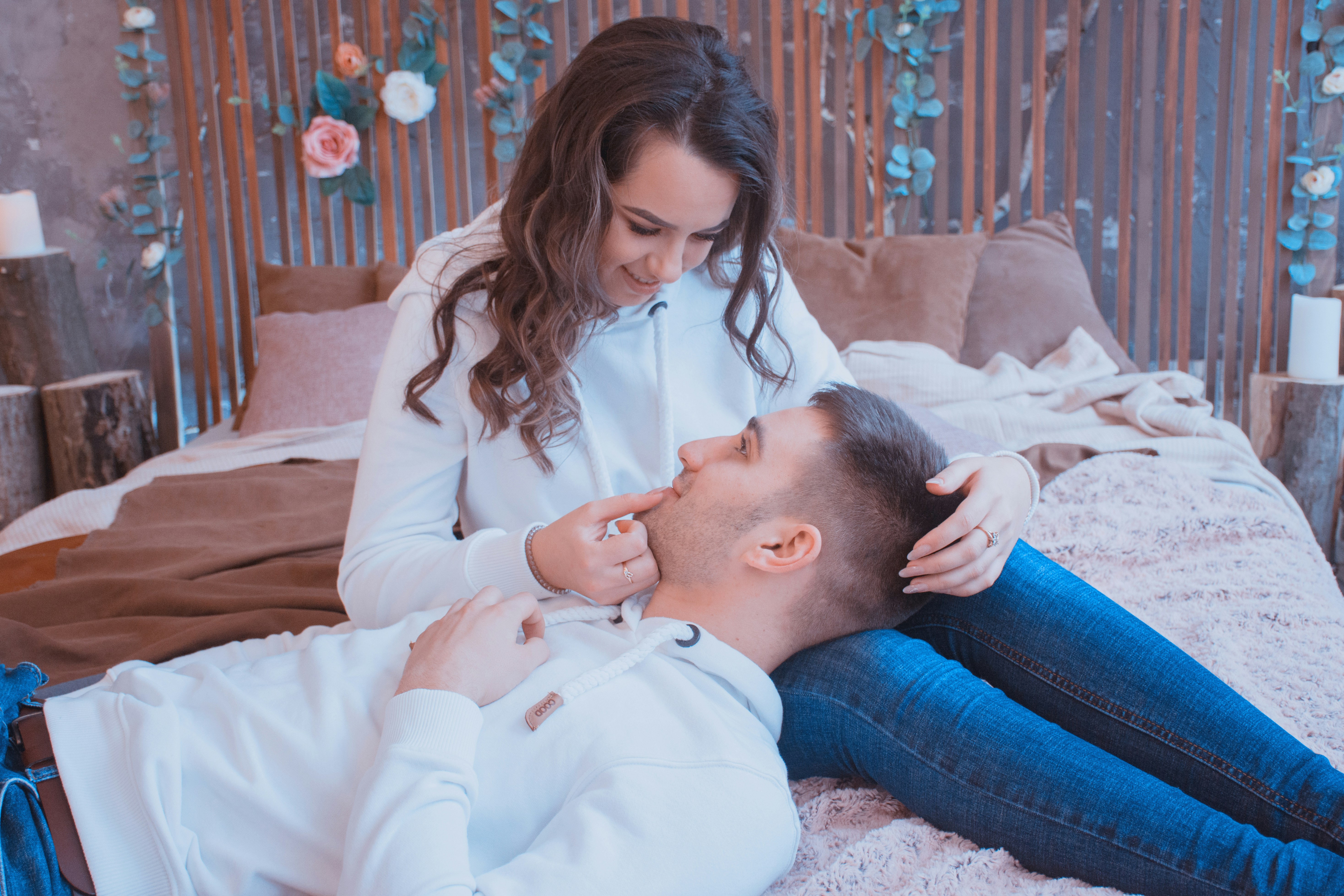 man and woman sitting on bed