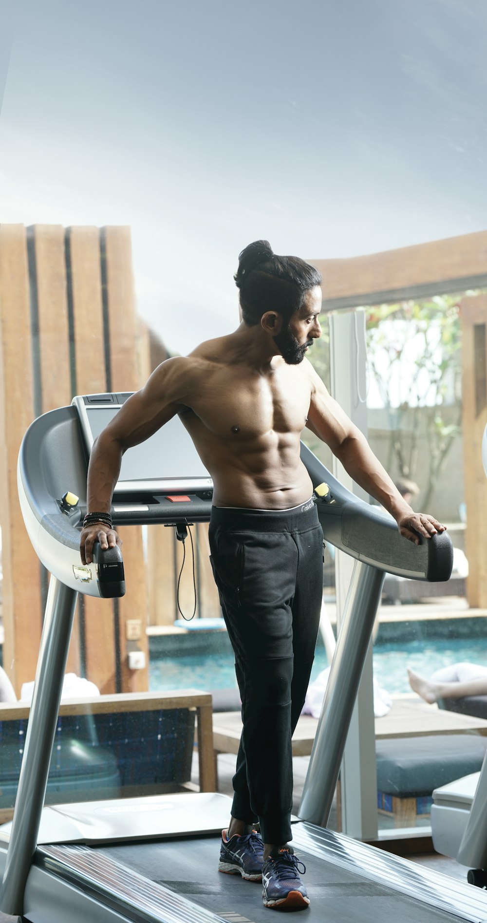 man standing on treadmill inside room