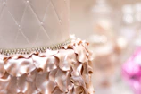 Close-up of an elegant pink and gold luxury cake with delicate floral decorations.