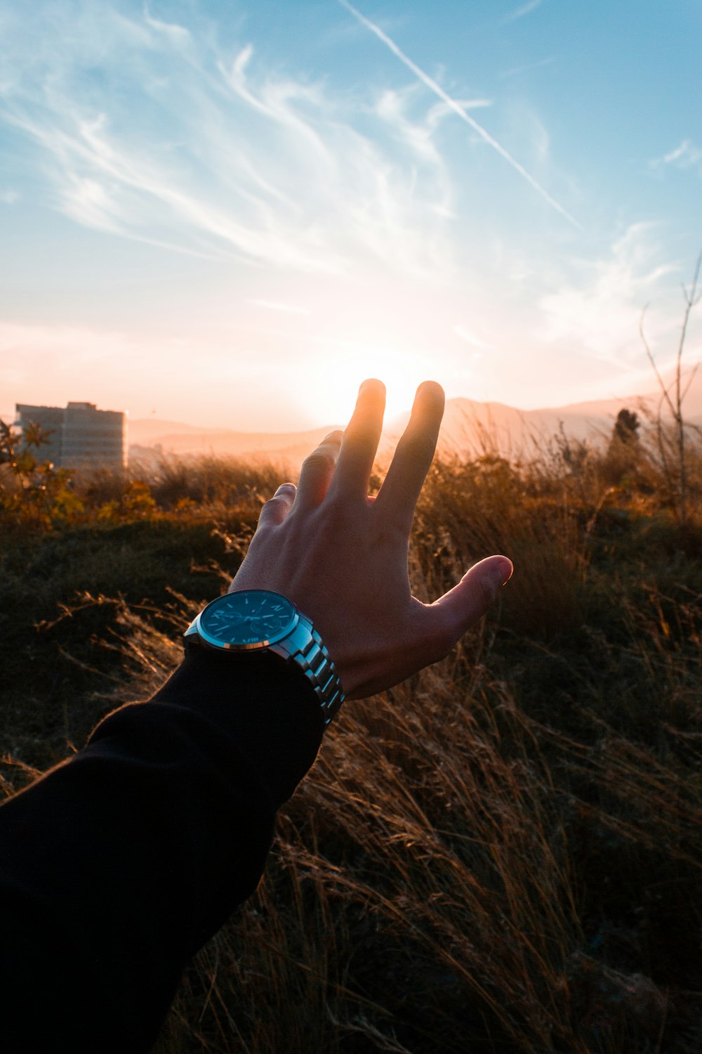 force perspective photography of person holding sun