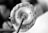 A close-up of a traditional spindle used for spinning cotton fibers. The image captures the detailed texture of the cotton wrapped around the spindle and the structural components of the tool.