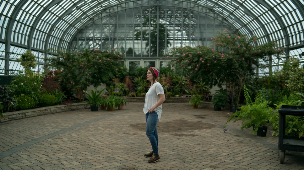 woman standing in the middle of garden